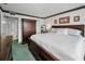 Spacious primary bedroom with a comfortable bed and a walk-in closet and carpet at 8 Glencoe Pl # 305, Dunedin, FL 34698