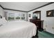 Bright primary bedroom featuring a large window offering a view and carpet at 8 Glencoe Pl # 305, Dunedin, FL 34698