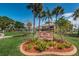 Office entrance with the Royal Stewart Arms sign, lush landscape, and ample parking at 8 Glencoe Pl # 305, Dunedin, FL 34698