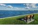 Scenic waterfront view with a bench to sit and relax and enjoy the water at 8 Glencoe Pl # 305, Dunedin, FL 34698