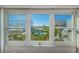 Scenic view of the communal park, pool, and neighboring buildings from the interior windows at 8 Glencoe Pl # 305, Dunedin, FL 34698