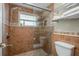 Bathroom includes a glass enclosed shower with tile walls and updated fixtures at 8240 144Th Ln, Seminole, FL 33776