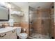 Stylish bathroom boasts a glass-enclosed shower and modern vanity with ample lighting at 8240 144Th Ln, Seminole, FL 33776