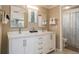 Bright bathroom with a double sink vanity, decorative mirrors and modern fixtures at 8240 144Th Ln, Seminole, FL 33776
