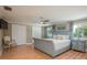 Comfortable bedroom with hardwood floors and a sitting chair by the window at 8240 144Th Ln, Seminole, FL 33776