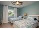 Comfortable bedroom featuring two twin beds with beach-themed bedding and a ceiling fan at 8240 144Th Ln, Seminole, FL 33776