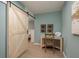 Bedroom view with desk, chair, and sliding barn door leading to another room at 8240 144Th Ln, Seminole, FL 33776