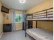 Functional bedroom featuring a bunk bed, dresser, and window at 8240 144Th Ln, Seminole, FL 33776
