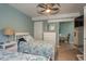 Well-lit bedroom showcases two twin beds, a dresser, and a small desk area at 8240 144Th Ln, Seminole, FL 33776