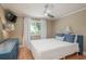 Bedroom features a queen bed, mounted TV and a large window with natural light at 8240 144Th Ln, Seminole, FL 33776