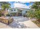 Charming two-story home with a circular driveway and lush tropical landscaping at 8240 144Th Ln, Seminole, FL 33776