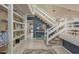 Spacious foyer with decorative shelving and a staircase with white railing at 8240 144Th Ln, Seminole, FL 33776