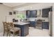 Modern kitchen with stainless steel appliances, navy cabinets, and a breakfast bar at 8240 144Th Ln, Seminole, FL 33776
