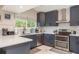 Modern kitchen with navy cabinets, white countertops, and stainless steel appliances at 8240 144Th Ln, Seminole, FL 33776