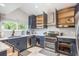 Spacious kitchen with navy cabinets, stainless steel appliances and white countertop at 8240 144Th Ln, Seminole, FL 33776