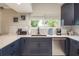 Bright kitchen features navy cabinets, stainless steel appliances, and natural light at 8240 144Th Ln, Seminole, FL 33776
