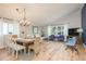 Open-concept living room features a dining area, neutral decor, and hardwood floors at 8240 144Th Ln, Seminole, FL 33776