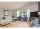Comfortable living room with large windows, neutral decor, and hardwood floors at 8240 144Th Ln, Seminole, FL 33776