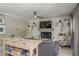 Cozy living room with a decorated fireplace, shelves, and comfortable seating at 8240 144Th Ln, Seminole, FL 33776