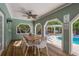Relaxing covered patio with a large dining table, ceiling fan, and view of the sparkling pool at 8240 144Th Ln, Seminole, FL 33776