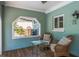 Cozy patio with wicker seating, wood floors, and decorative table at 8240 144Th Ln, Seminole, FL 33776