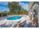 Private backyard pool with ample lounge seating and access to the covered patio at 8240 144Th Ln, Seminole, FL 33776