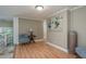 Neutral room with hardwood floors, a seating area, and artwork, showcasing a versatile space at 8240 144Th Ln, Seminole, FL 33776