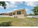 Expansive backyard with a well-kept lawn and a secure white picket fence at 9917 Prevatt St, Gibsonton, FL 33534