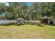 Landscaped backyard featuring a gazebo, shed, and privacy fence at 9917 Prevatt St, Gibsonton, FL 33534