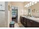 Bathroom showcases a double vanity with views to the bedroom through an open doorway at 9917 Prevatt St, Gibsonton, FL 33534