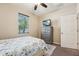Bright bedroom featuring a window, TV, and ample storage space at 9917 Prevatt St, Gibsonton, FL 33534