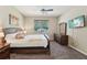 Bedroom showcases a bed, dresser, TV, and large window at 9917 Prevatt St, Gibsonton, FL 33534