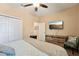Well-lit bedroom with a double bed, closet, and dresser with a TV at 9917 Prevatt St, Gibsonton, FL 33534
