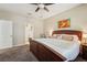 Bedroom features a large bed, ceiling fan, and doorway to the Primary bath at 9917 Prevatt St, Gibsonton, FL 33534