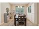 Bright dining room features a large window and built-in storage cabinets with seating for six at 9917 Prevatt St, Gibsonton, FL 33534
