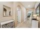 Hallway featuring neutral paint, tile flooring, arched doorways, and decorative accents at 9917 Prevatt St, Gibsonton, FL 33534