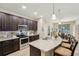 Modern kitchen with granite countertops, stainless steel appliances, and seating at the island at 9917 Prevatt St, Gibsonton, FL 33534