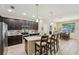 Modern kitchen with granite countertops, stainless steel appliances, and seating at the island at 9917 Prevatt St, Gibsonton, FL 33534