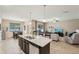 Open floor plan from kitchen to living room with sliding glass door access to the outdoors at 9917 Prevatt St, Gibsonton, FL 33534