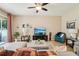 Comfortable living room featuring tile floors, plush seating, and access to the screened-in patio at 9917 Prevatt St, Gibsonton, FL 33534