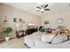 Cozy living room with tile floors, a ceiling fan, comfortable seating, and modern décor at 9917 Prevatt St, Gibsonton, FL 33534