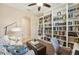 Inviting living room with built-in bookshelves, comfortable seating, and contemporary decor at 9917 Prevatt St, Gibsonton, FL 33534