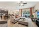 Open-concept living room with tile floors, ceiling fan, and sliding glass doors leading to the patio at 9917 Prevatt St, Gibsonton, FL 33534