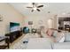 Bright living room with tile floors, a ceiling fan, comfortable seating, and stylish decor at 9917 Prevatt St, Gibsonton, FL 33534