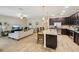 Open-concept kitchen and living room with granite countertops, stainless steel appliances, and tile flooring at 9917 Prevatt St, Gibsonton, FL 33534