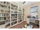 Well-lit home office featuring custom built-in bookshelves and dedicated workspace at 9917 Prevatt St, Gibsonton, FL 33534