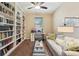 Cozy office features a large built-in bookcase, desk, and comfortable seating at 9917 Prevatt St, Gibsonton, FL 33534
