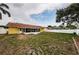 Large, fenced backyard with a covered patio, ideal for outdoor activities and gatherings at 10051 82Nd Ln, Seminole, FL 33777