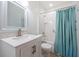 This bathroom features a modern vanity with granite countertop and a tiled shower and bathtub at 10051 82Nd Ln, Seminole, FL 33777