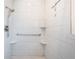 This renovated bathroom features white tile, a built-in shower and safety grab bars at 10051 82Nd Ln, Seminole, FL 33777